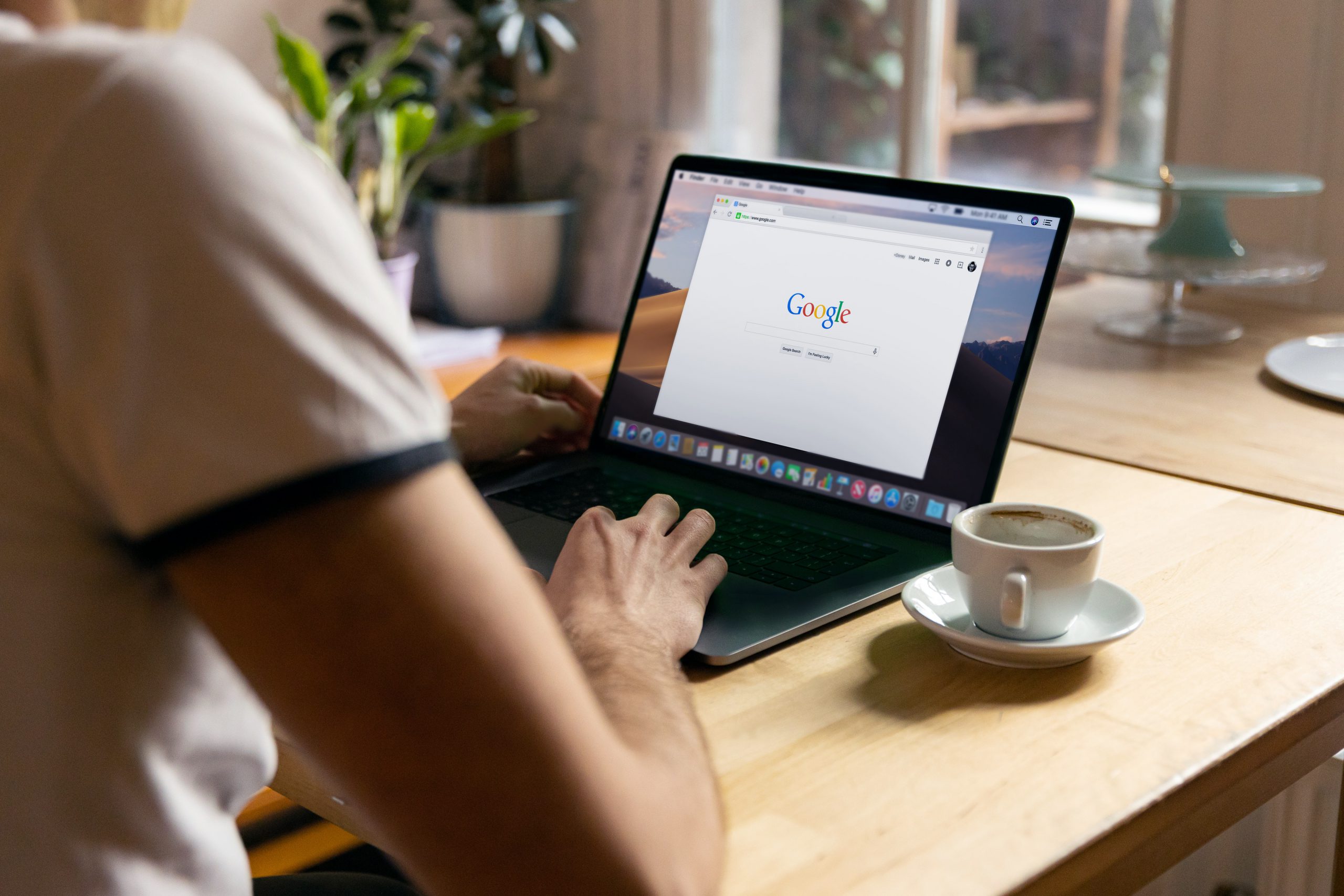 Mann sucht auf Laptop in Google